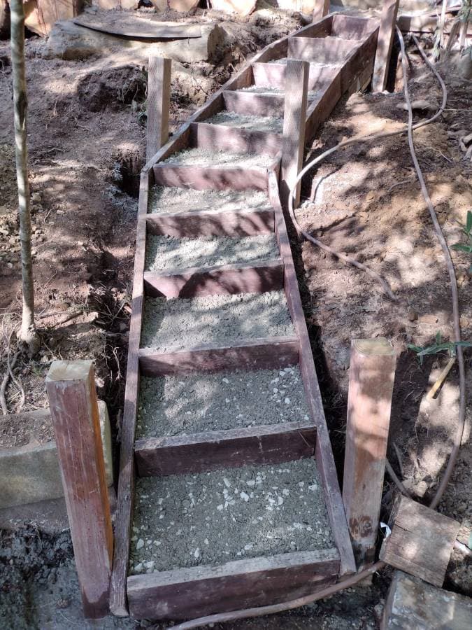 Outdoor stair construction using stone steps on sloped terrain